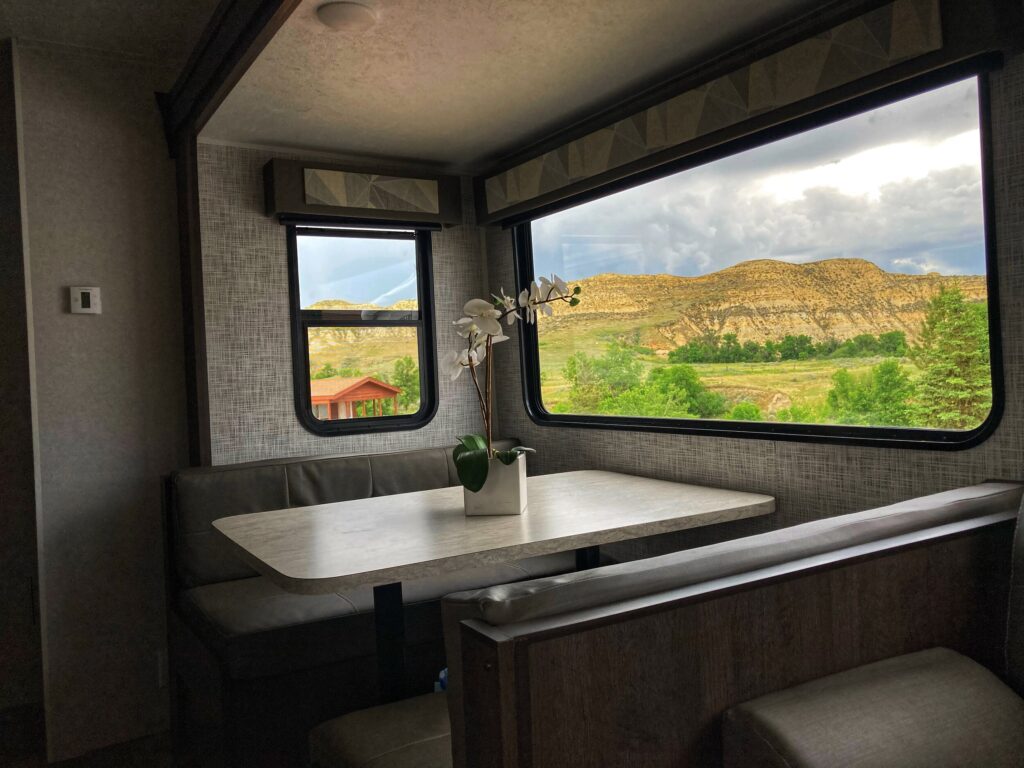 Inside of RV with scenery visible through the window