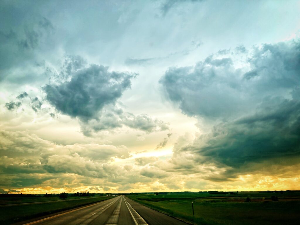 a sunset with a highway stretching out