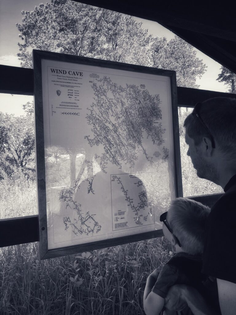 father and son reading a map