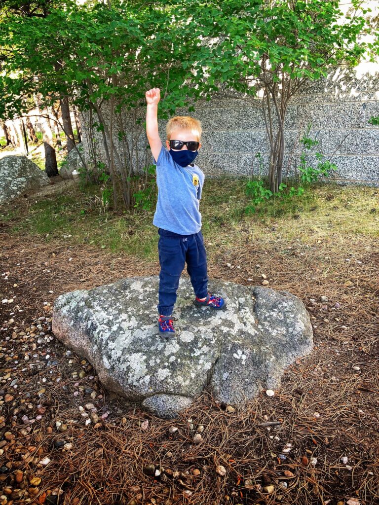 Owen in a mask on a rock