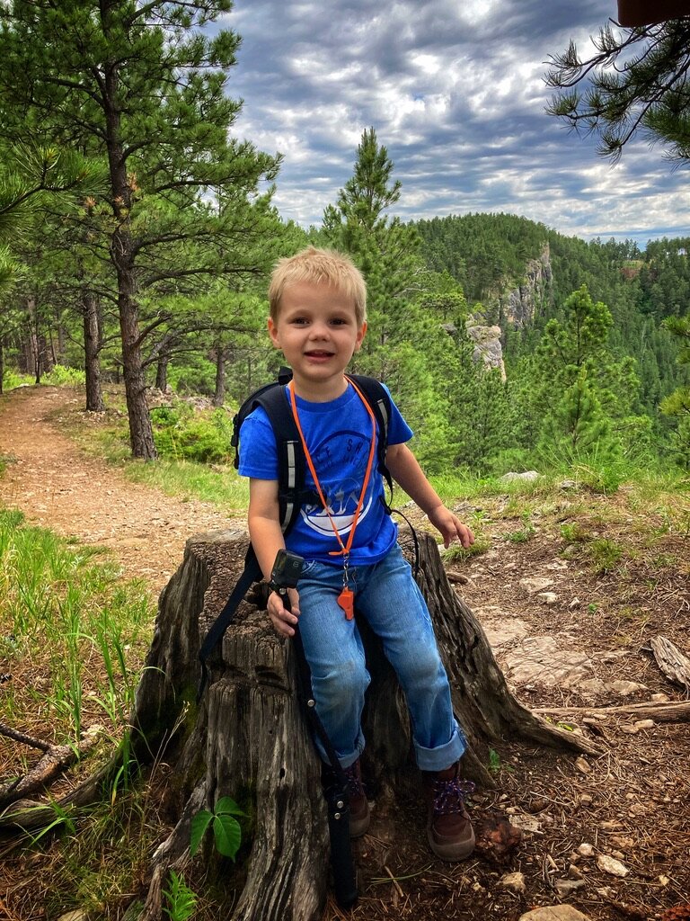 Kid on a tree stump